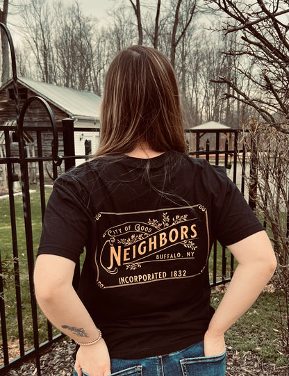 Woman wearing black tshirt outside that reads city of good neighbors
