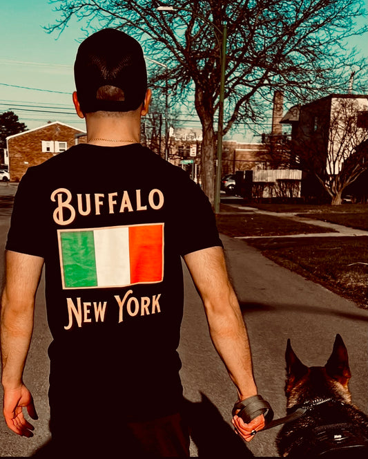 Man wearing buffalo ny shirt with Italy flag and walking dog