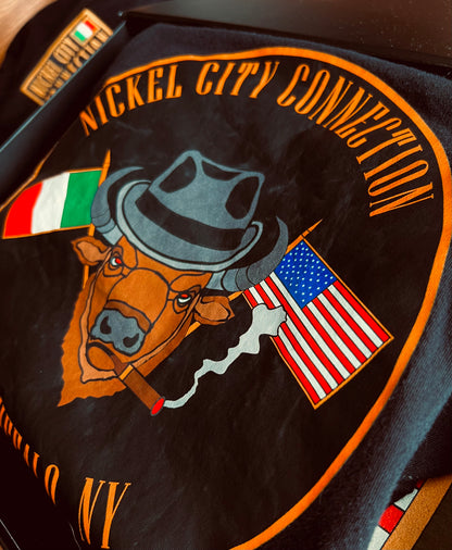 Bison with fedora and US and Italy flags crossed while smoking a cigar. In black tshirt that is in a box