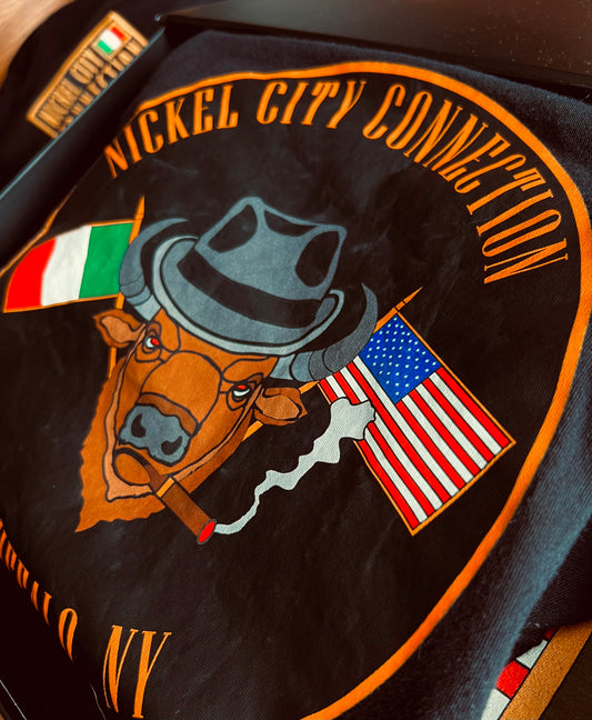 Bison with fedora and US and Italy flags crossed while smoking a cigar. In black tshirt that is in a box