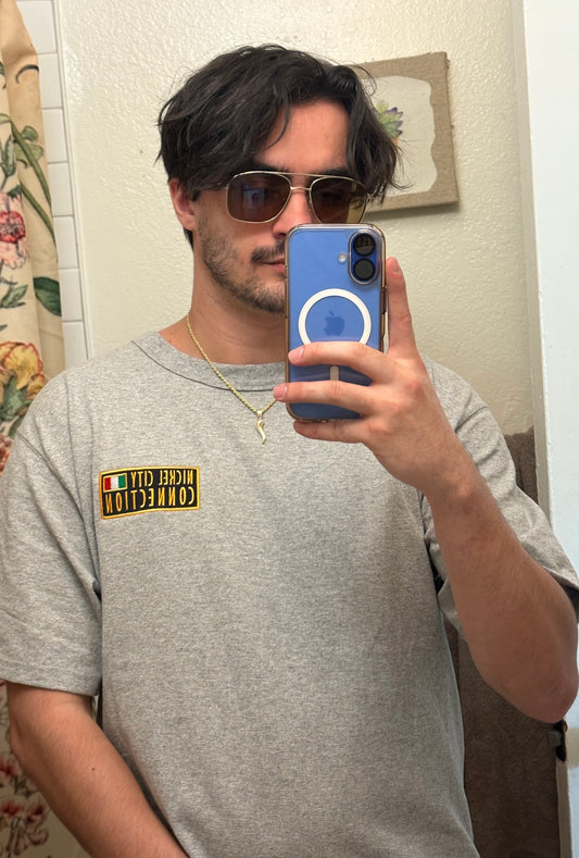 Man wearing nickel city connection grey shirt with embroidered patch Italy flag on it