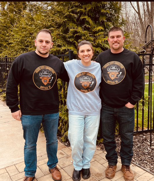 3 people wearing Nickel City Connection sweatshirts