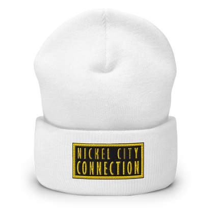 White beanie featuring  a bold "Nickel City Connection" logo in gold and black, featuring a strong, clean design within a rectangular border.