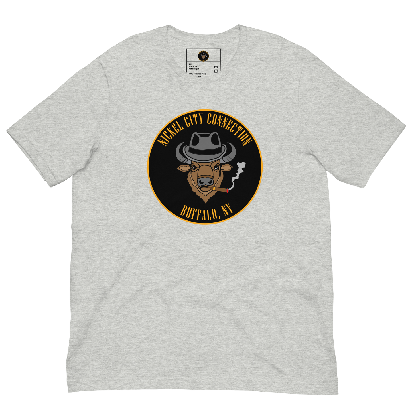 Grey t-shirt with a Logo featuring a stylized bison head wearing a fedora, smoking a cigar with visible smoke. The circular design includes bold gold text reading 'Nickel City Connection' at the top and 'Buffalo, NY' at the bottom, outlined in gold against a black background.