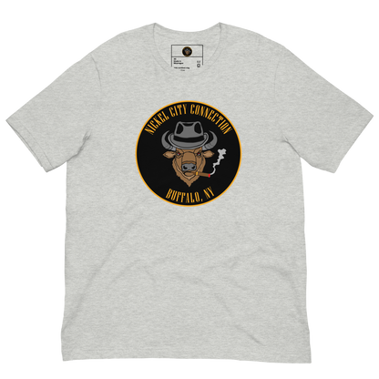 Grey t-shirt with a Logo featuring a stylized bison head wearing a fedora, smoking a cigar with visible smoke. The circular design includes bold gold text reading 'Nickel City Connection' at the top and 'Buffalo, NY' at the bottom, outlined in gold against a black background.