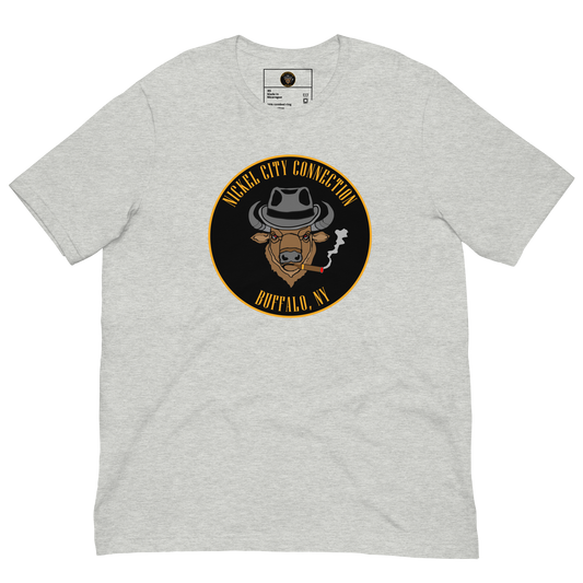 Grey t-shirt with a Logo featuring a stylized bison head wearing a fedora, smoking a cigar with visible smoke. The circular design includes bold gold text reading 'Nickel City Connection' at the top and 'Buffalo, NY' at the bottom, outlined in gold against a black background.