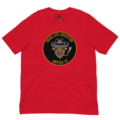 Red t-shirt with a Logo featuring a stylized bison head wearing a fedora, smoking a cigar with visible smoke. The circular design includes bold gold text reading 'Nickel City Connection' at the top and 'Buffalo, NY' at the bottom, outlined in gold against a black background.